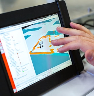 person holding black tablet computer