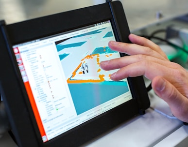 person holding black tablet computer